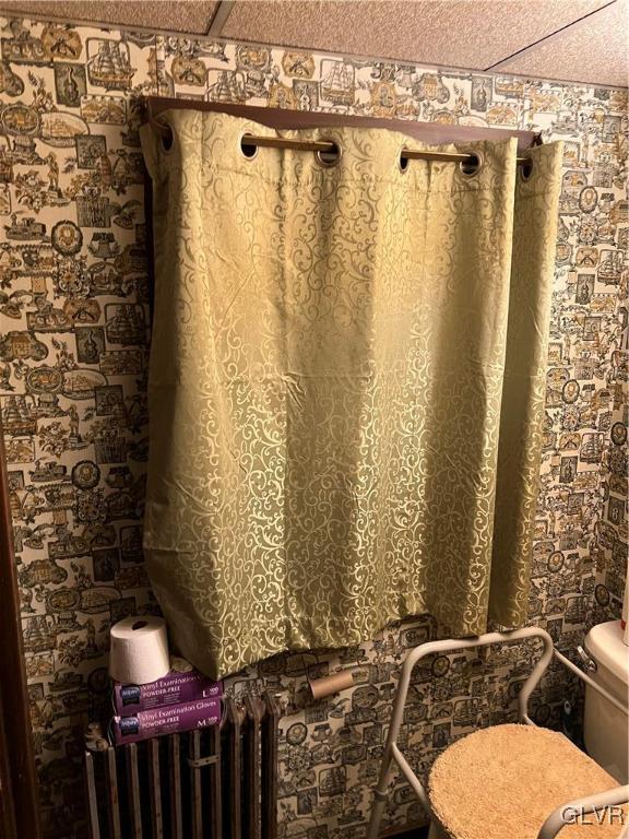 bathroom featuring a textured ceiling and toilet