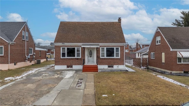 bungalow featuring central AC and a front yard