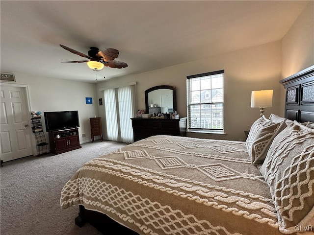 bedroom featuring multiple windows, light colored carpet, and ceiling fan