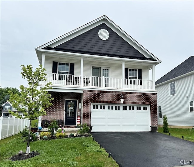 view of front facade featuring a garage, covered porch, and a front lawn