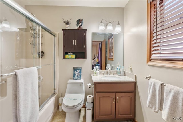 full bathroom with vanity, enclosed tub / shower combo, and toilet