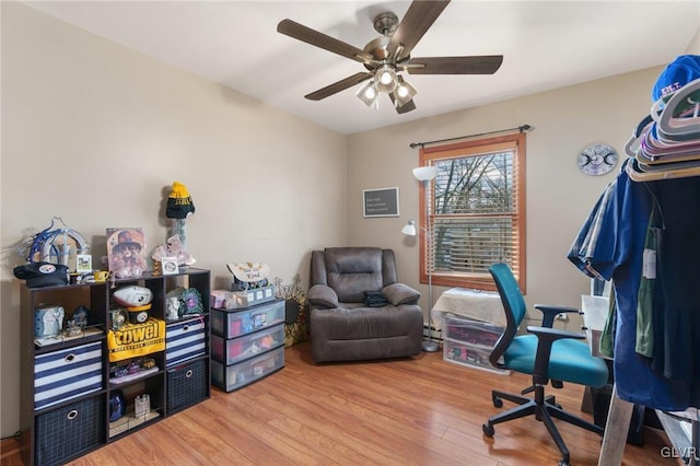 home office featuring hardwood / wood-style floors and ceiling fan