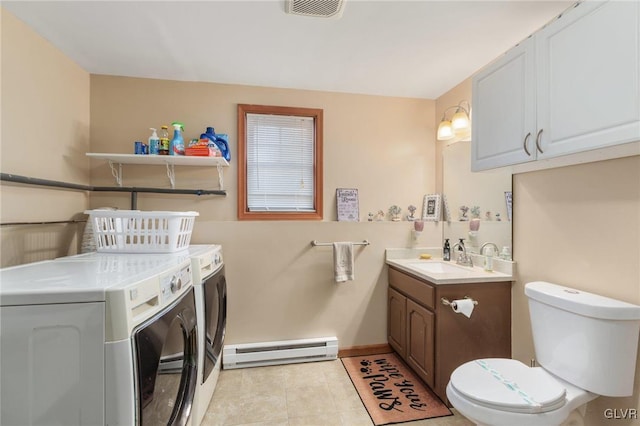 bathroom with baseboard heating, tile patterned flooring, independent washer and dryer, vanity, and toilet