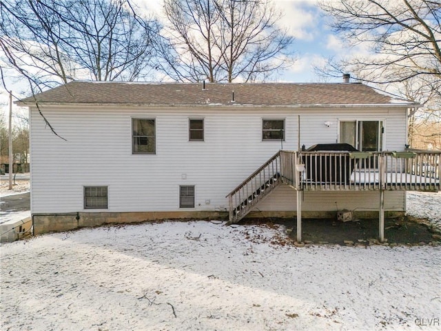 snow covered house with a deck