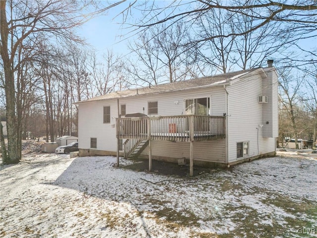 snow covered property with a wooden deck