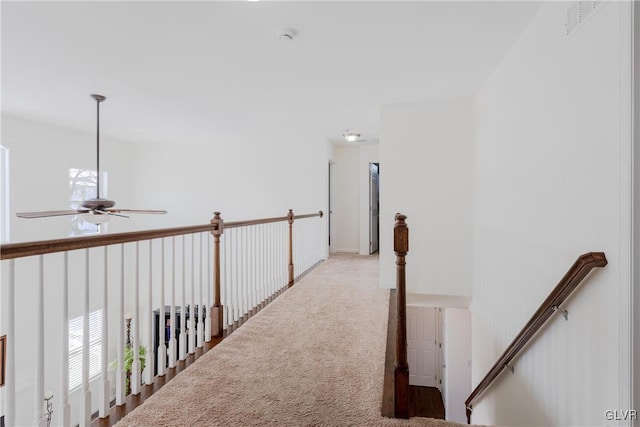 hall featuring light colored carpet