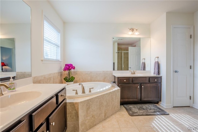 bathroom featuring tile patterned floors, plus walk in shower, and vanity