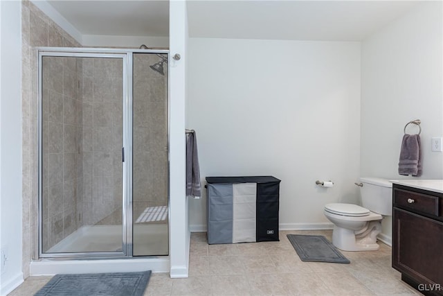 bathroom with vanity, tile patterned floors, toilet, and walk in shower