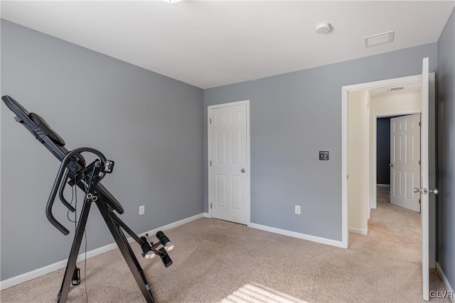 exercise room with light carpet