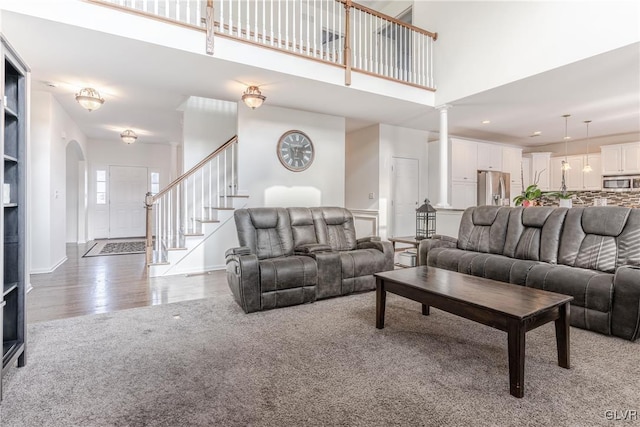 living room featuring hardwood / wood-style flooring and a high ceiling