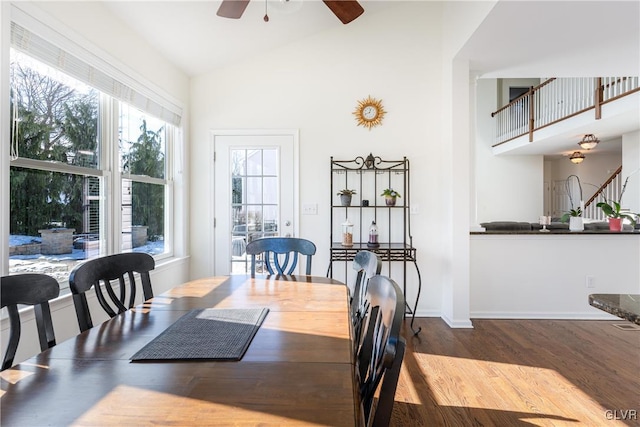 dining space with ceiling fan, wood-type flooring, and high vaulted ceiling