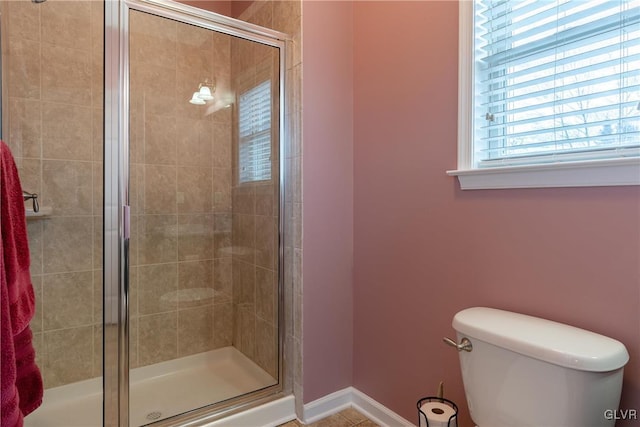 bathroom with an enclosed shower and toilet