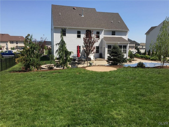 rear view of house featuring a patio area and a lawn