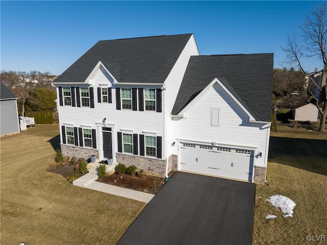 view of front of home featuring a garage and a front yard