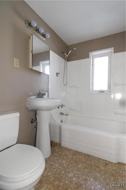 bathroom featuring shower / tub combination and toilet