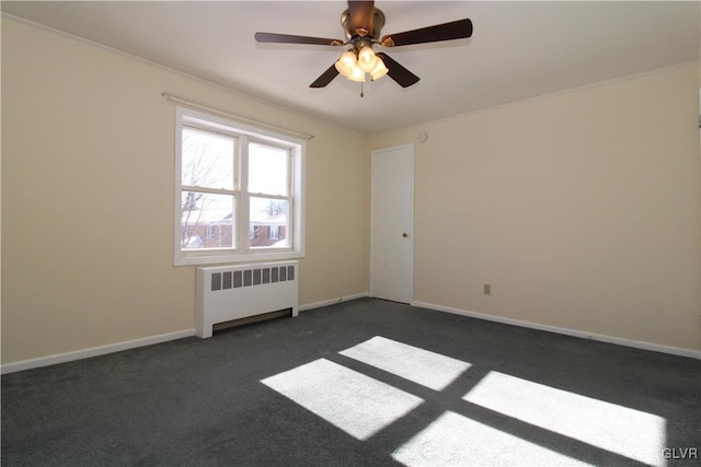 carpeted empty room featuring ceiling fan and radiator heating unit