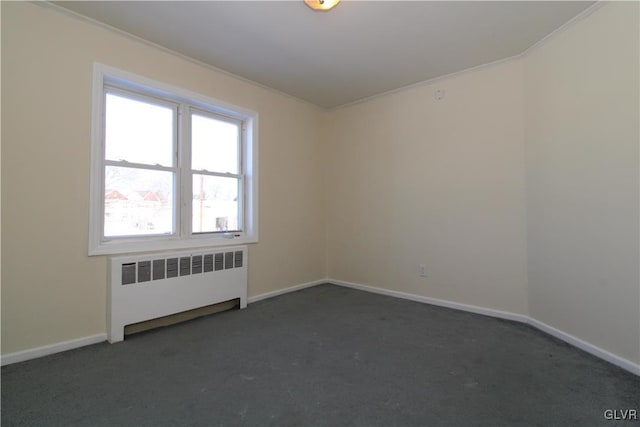 carpeted empty room featuring crown molding and radiator