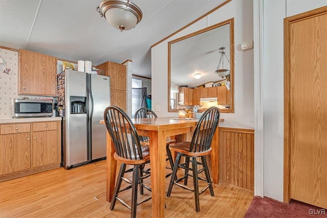 kitchen with stainless steel appliances and light hardwood / wood-style flooring