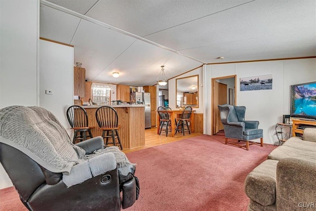 living room featuring vaulted ceiling and light colored carpet