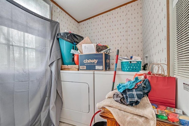 clothes washing area featuring ornamental molding and washing machine and dryer