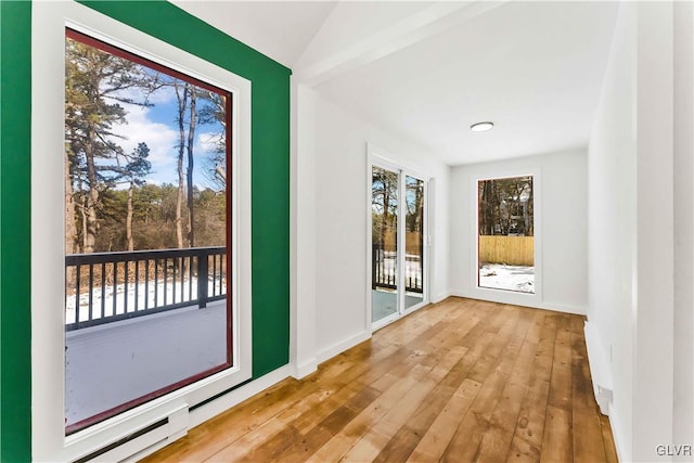 entryway with baseboard heating and hardwood / wood-style floors