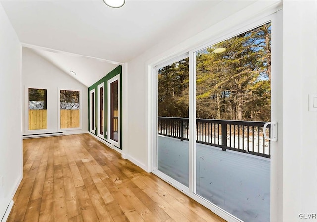 interior space with lofted ceiling and baseboard heating