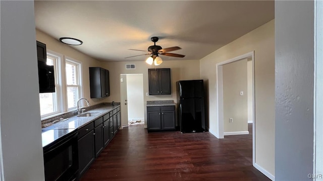 kitchen with dark hardwood / wood-style flooring, sink, ceiling fan, and black fridge