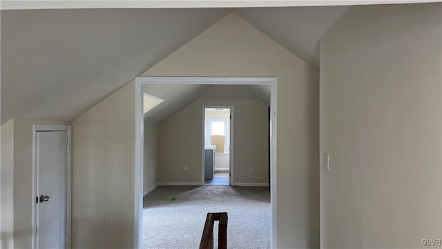 bonus room with vaulted ceiling and carpet