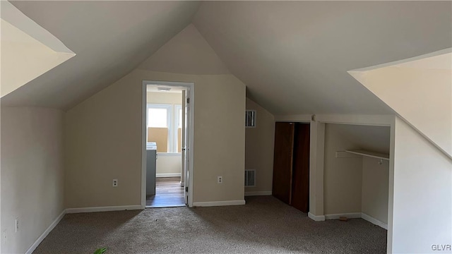 bonus room featuring lofted ceiling and carpet flooring