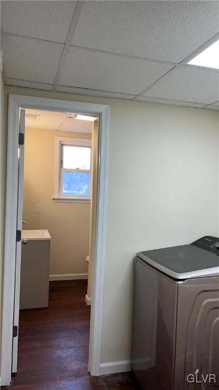 clothes washing area with dark hardwood / wood-style floors and washer / dryer