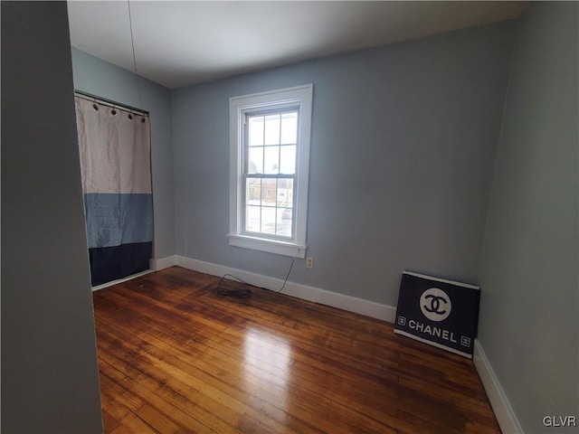 empty room featuring dark hardwood / wood-style flooring