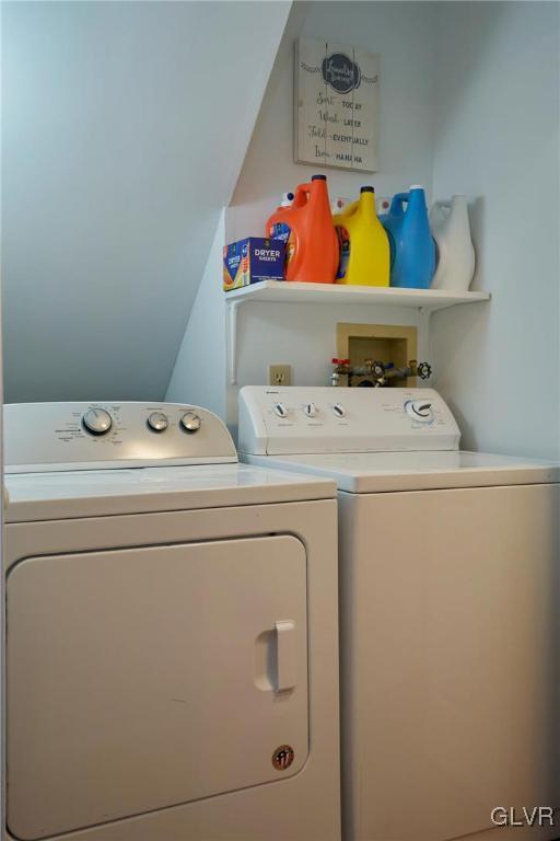 washroom with washing machine and clothes dryer