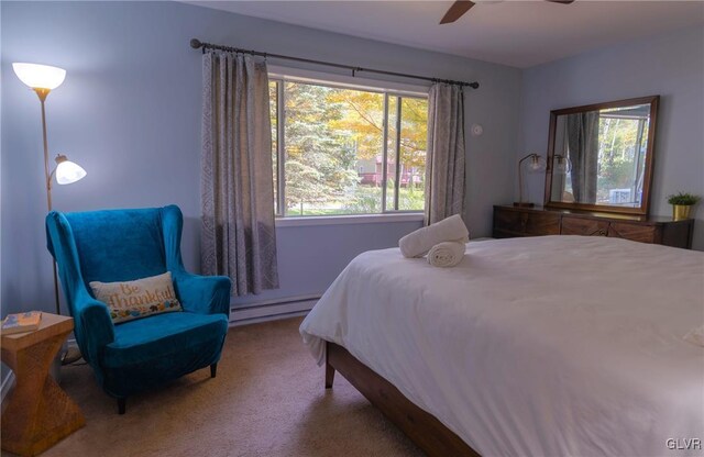 bedroom featuring ceiling fan, a baseboard radiator, and carpet