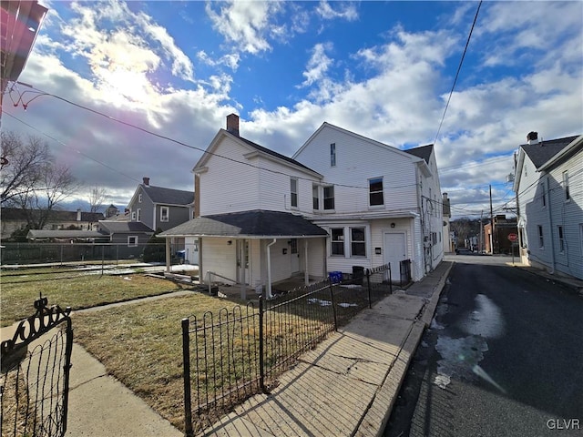 rear view of house with a lawn