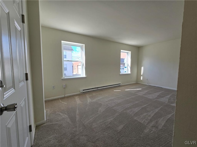 unfurnished room with baseboard heating and dark colored carpet