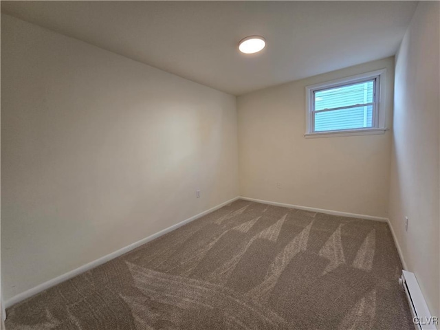 carpeted empty room with a baseboard heating unit