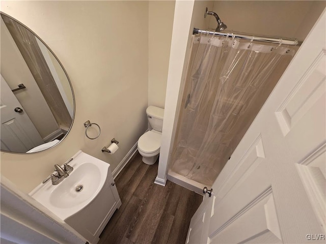 bathroom featuring vanity, hardwood / wood-style floors, a shower with curtain, and toilet