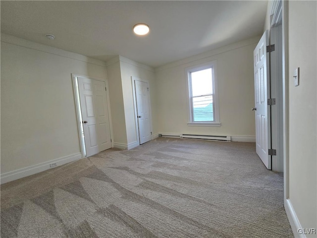 unfurnished bedroom featuring baseboard heating and light carpet