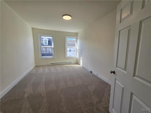 unfurnished room with light colored carpet and baseboard heating