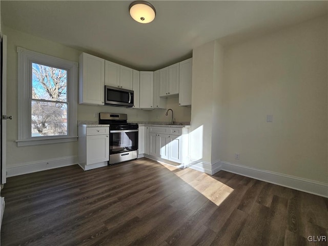 kitchen with white cabinetry, sink, dark hardwood / wood-style flooring, and appliances with stainless steel finishes