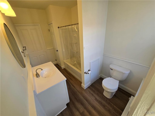 full bathroom featuring vanity, hardwood / wood-style floors, toilet, and shower / bathtub combination with curtain