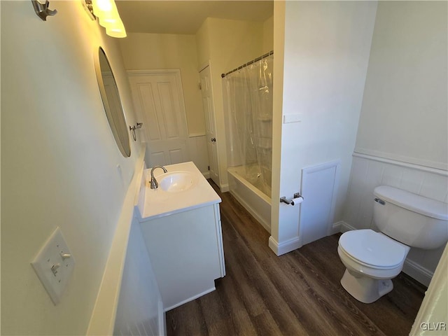 full bathroom with vanity, toilet, hardwood / wood-style floors, and shower / bath combo