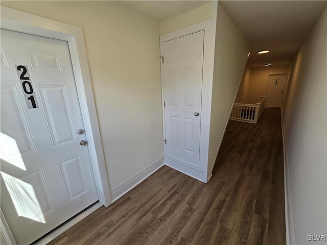 corridor with dark hardwood / wood-style floors