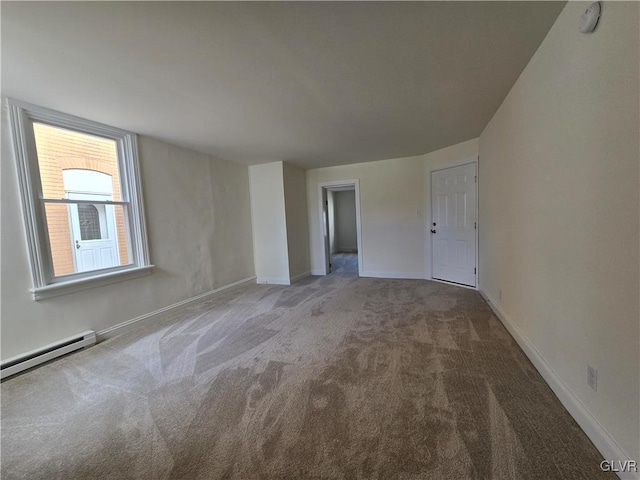 unfurnished room with carpet floors and a baseboard radiator