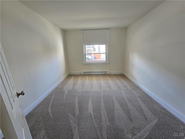 empty room with a baseboard radiator and light colored carpet