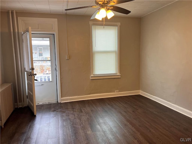 interior space featuring dark hardwood / wood-style flooring, radiator, and ceiling fan