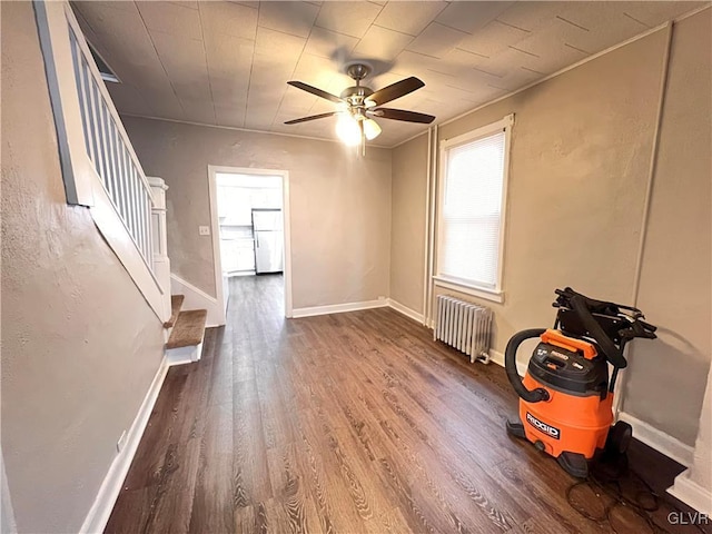 spare room with radiator, hardwood / wood-style floors, and ceiling fan