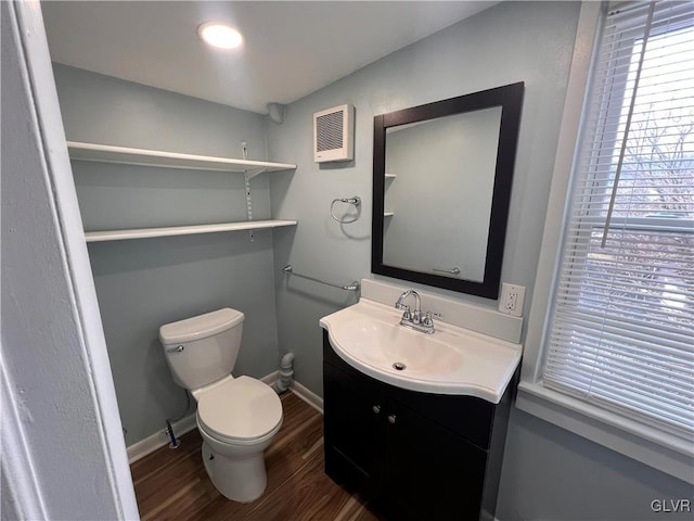 bathroom with vanity, toilet, and hardwood / wood-style floors