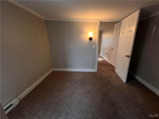 spare room with crown molding, dark carpet, and baseboard heating