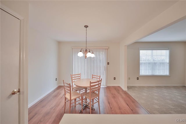 dining space featuring a notable chandelier and light hardwood / wood-style floors